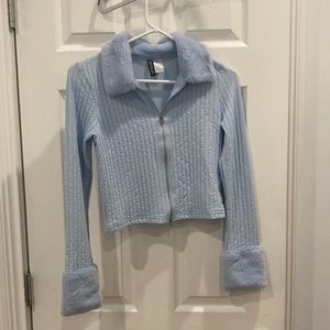 Blue zip up sweater with faux fur around the neck and wrists